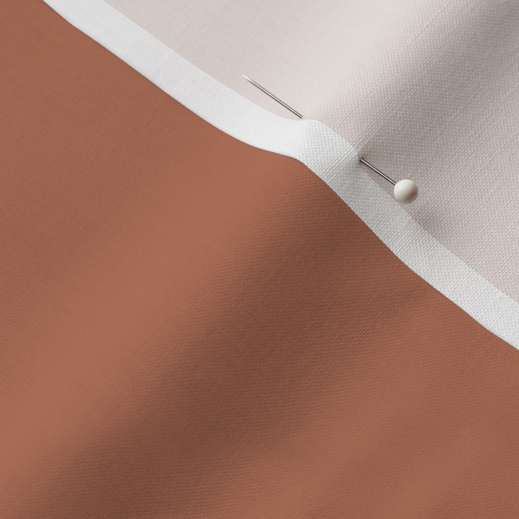 Close-up of vintage soft clay cotton fabric showing the finished edge and texture.