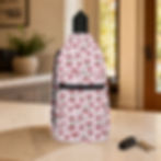 Vintage Pink Cherry sling bag facing forward on a kitchen counter beside car keys.