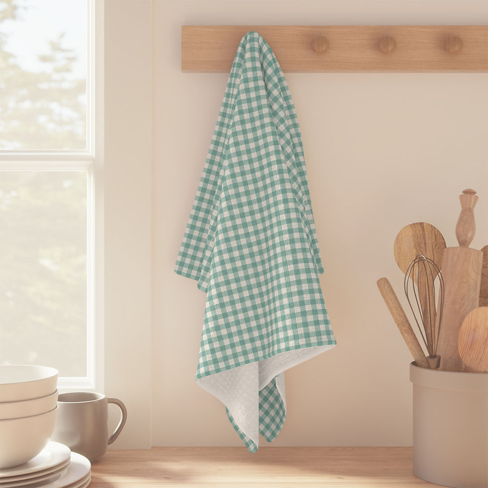 Sage green gingham kitchen towel hanging on a wall hook in a farmhouse kitchen.