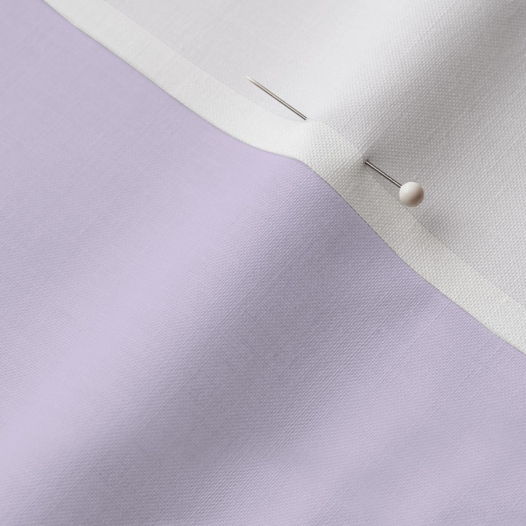 Close-up of lavender Cotton Prima fabric showing the finished edge and texture.