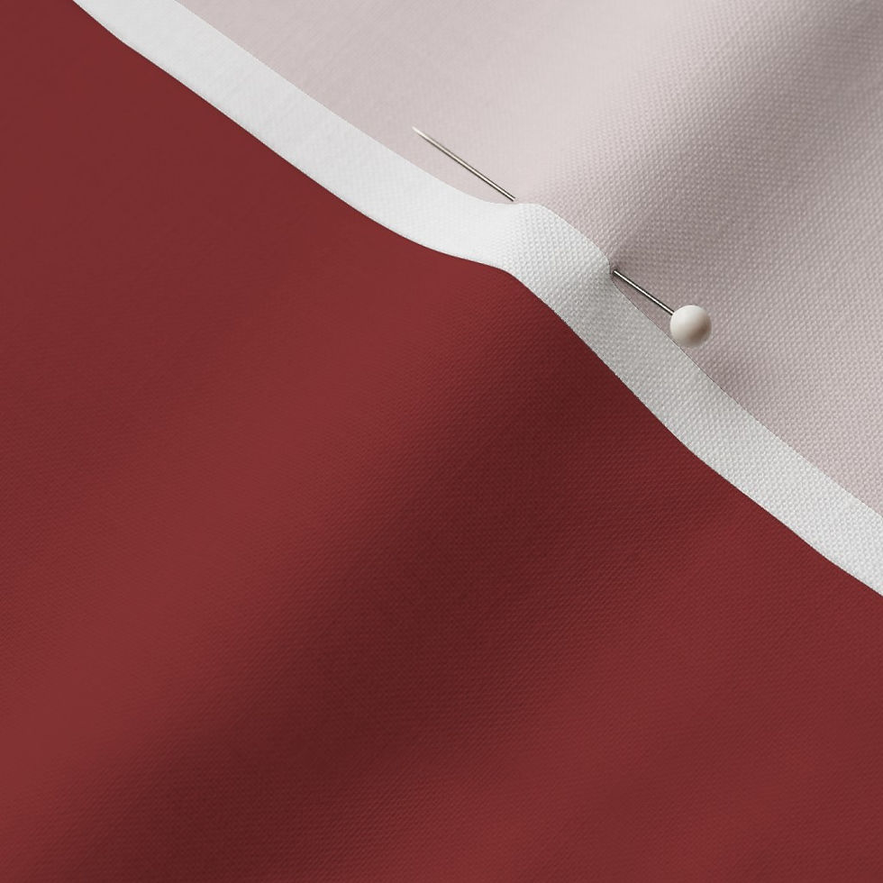 Close-up of Barn Red Cotton Prima fabric showing the finished edge and texture.