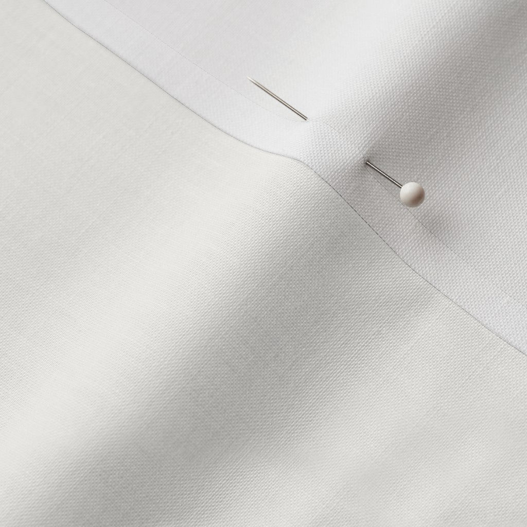 Close-up of Soft Porcelain White Cotton Prima fabric showing the finished edge and texture.