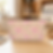 Blush pink watercolor floral T-bottom pouch lying on a craft table.