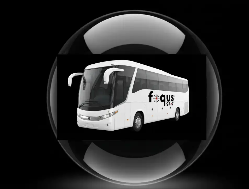 White bus with "focus 24x7" logo on its side, set against a dark background, reflecting in a glossy black sphere.