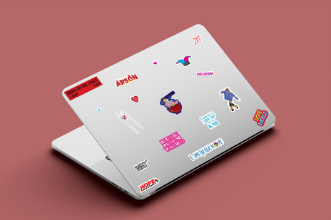 A silver laptop decorated with various j-hope-inspired stickers from the Hope on the Stage sticker sheet, including references to Arson, Hope World, Hope on the Street Vol.1, and Jack in the Box, against a muted red background.