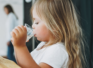 cute-toddler-girl-drinking-water-YQXRKWB