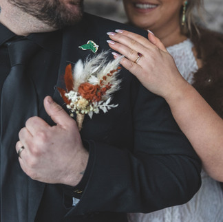 Groom's preserved terracotta rose buttonhole with dried flowers and eucalyptus.