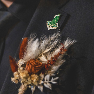 Preserved groom's buttonhole with terracotta rose and dried floral details