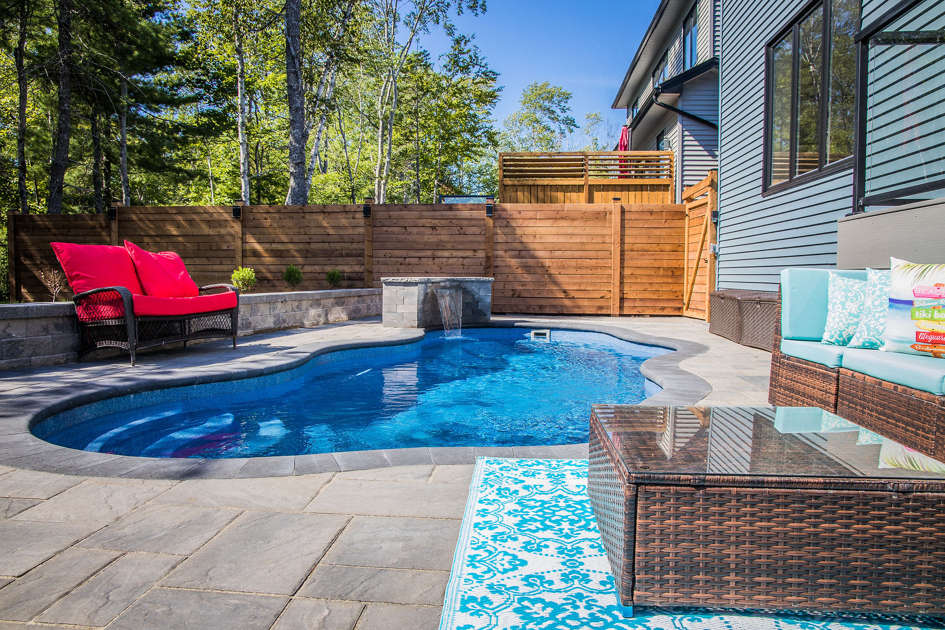 small backyard in Bedford, Nova Scotia with pool, waterfall and space for entertraining