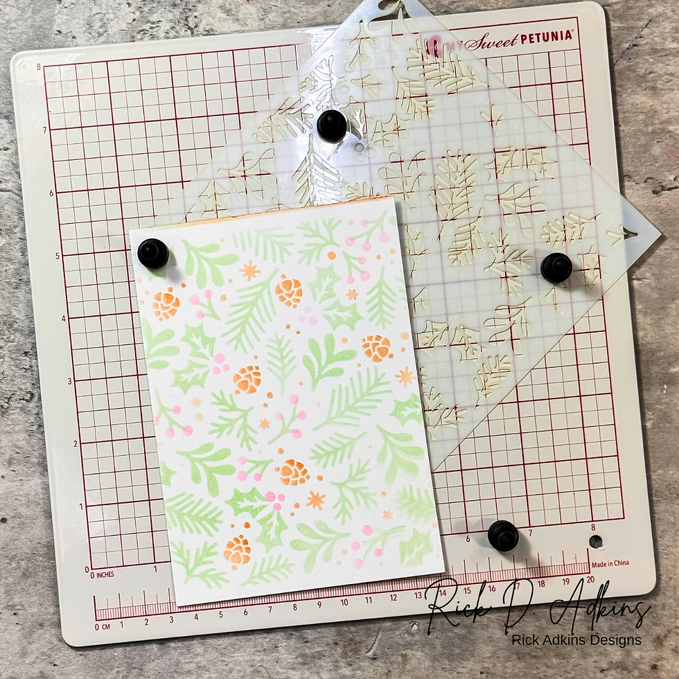 Crafting stencil on grid board with floral design card featuring green leaves and orange flowers. Text: Sweet Petunia, Rick Adkins Designs.