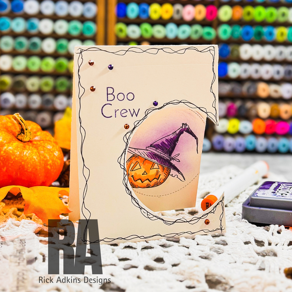 Handmade Boo Crew Halloween card with a pumpkin in a witch hat, surrounded by colorful craft supplies and pumpkins.