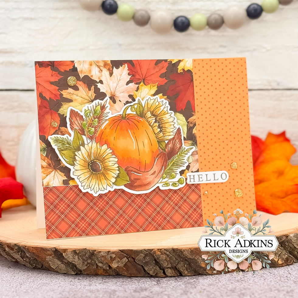 Fall-themed card with pumpkin, sunflowers, plaid and polka dot patterns, and "HELLO" text. Background features autumn leaves.