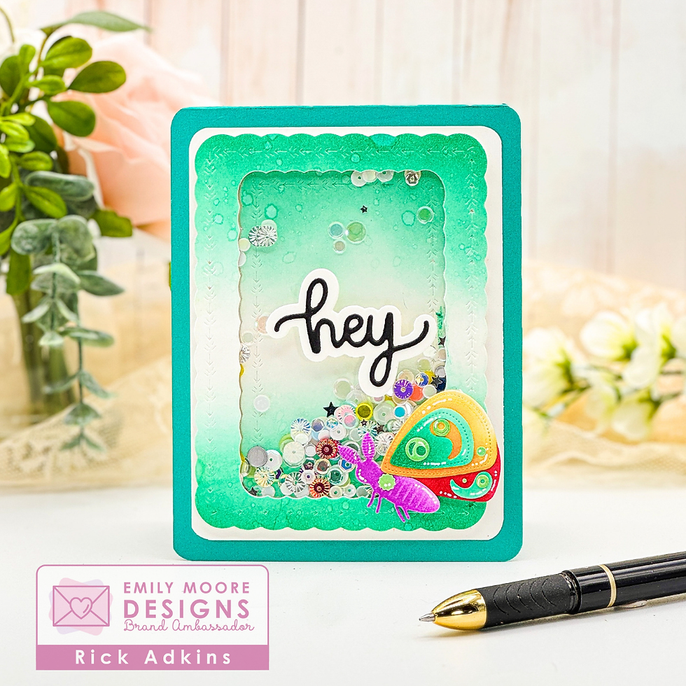 Greeting card with "hey" text in bold, surrounded by sequins. Features a colorful, abstract butterfly. Background: flowers, pen, and greenery.