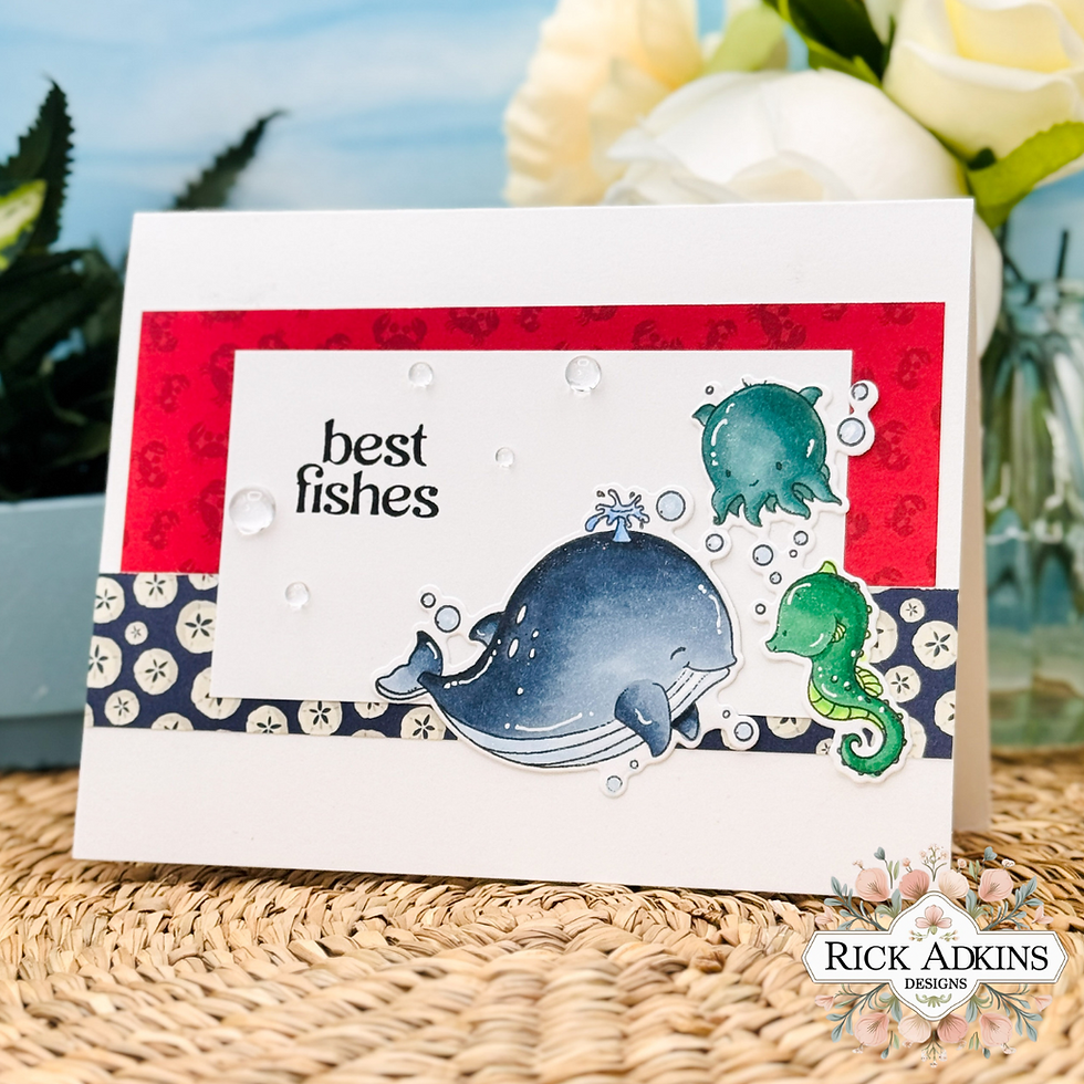 Greeting card with a smiling whale, fish, and seahorse on a red and blue patterned background. Text reads "best fishes." Floral decor in corner.