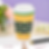 A decorative coffee cup sleeve with "Central Perk" text and cup patterns. Set on a table with flowers, a pen, and a purple patterned wall.
