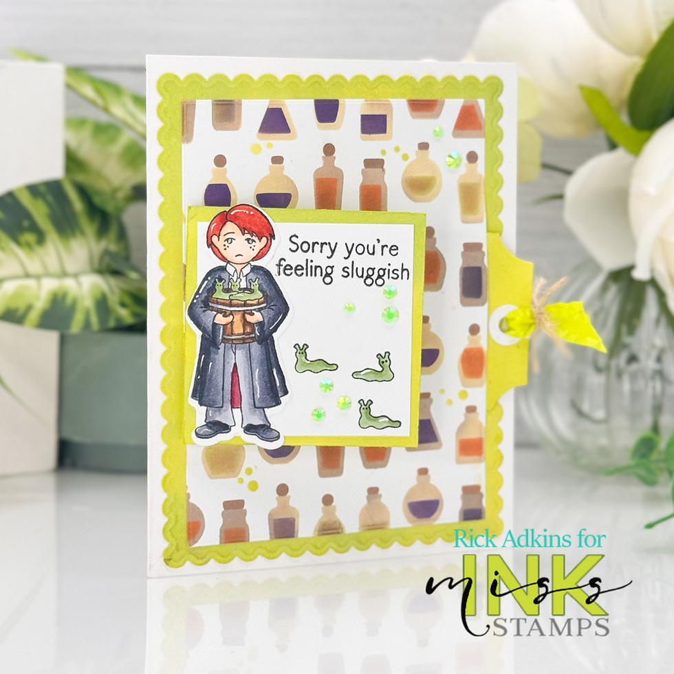 Greeting card with potion-themed background, cartoon character holding bubbling pot. Text reads "Sorry you're feeling sluggish" with slugs. Bright and playful.