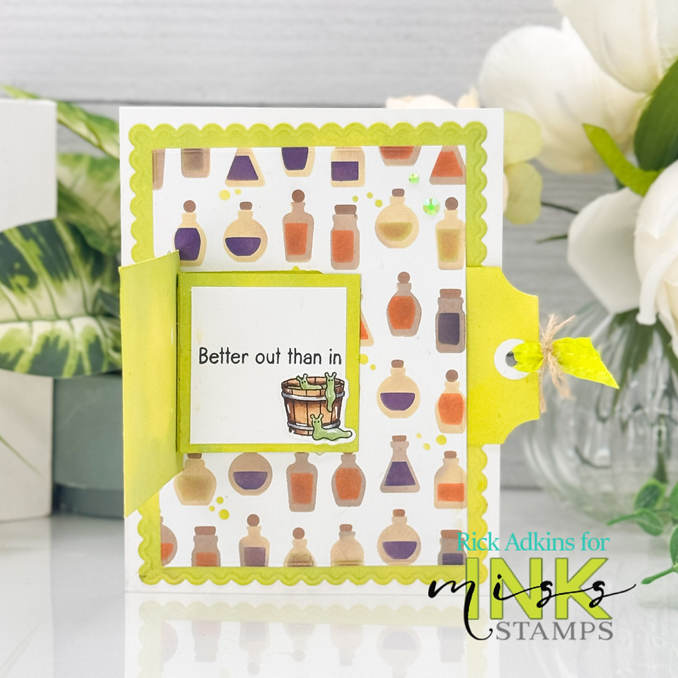 Card with potion bottle pattern, green accents, and text "Better out than in" above a cauldron with creature. Bright, playful design.