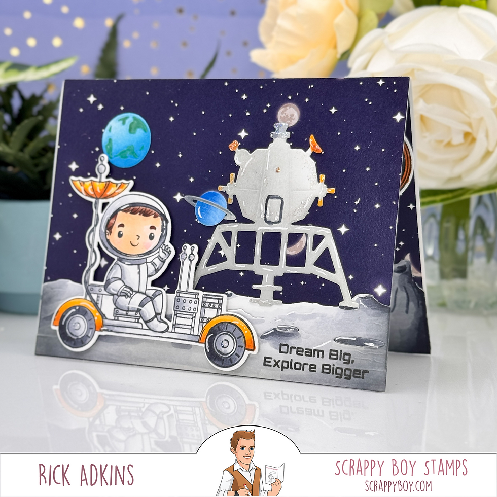 Astronaut boy on a cart waves on a starry card with planets and a lunar lander. Text: "Dream Big, Explore Bigger." Flowers in background.