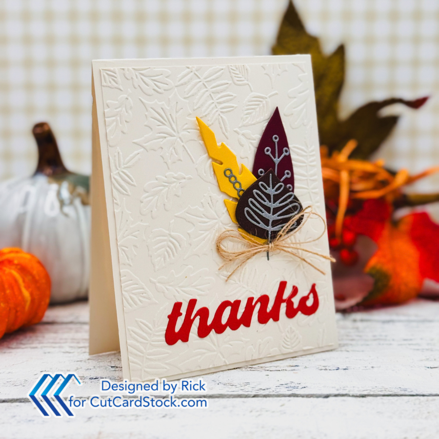 Autumn thank-you card with embossed leaves, layered paper leaves, twine bow, and pumpkins; Designed by Rick for CutCardStock.com.