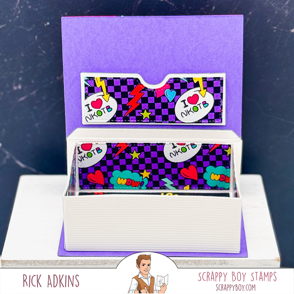 Purple checkered box with "I ♥ NKOTB" and "WDW" on it, displayed on a stand. Lightning bolts and stars are visible.