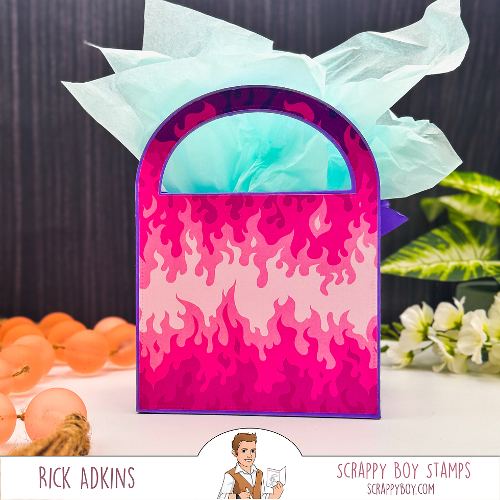 Pink gift bag with flame pattern, blue tissue paper inside. Surrounded by flowers and orange beads. Text: "Rick Adkins, Scrappy Boy Stamps."