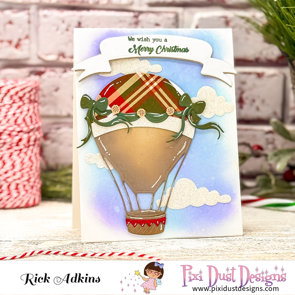 Christmas card with a festive hot air balloon on a blue background. Text reads "We wish you a Merry Christmas." Red and green plaid details.