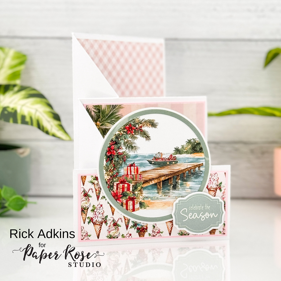 Festive card with a beach scene, gifts by a dock, palm wreath, and "celebrate the Season" text. Pink patterns and greenery in background.