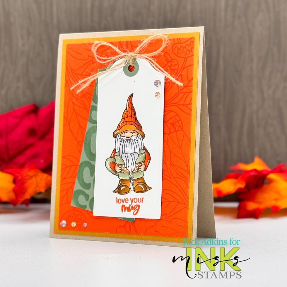 Greeting card with gnome holding a mug on an orange background. Text reads "love your mug." Autumn leaves and wooden backdrop.