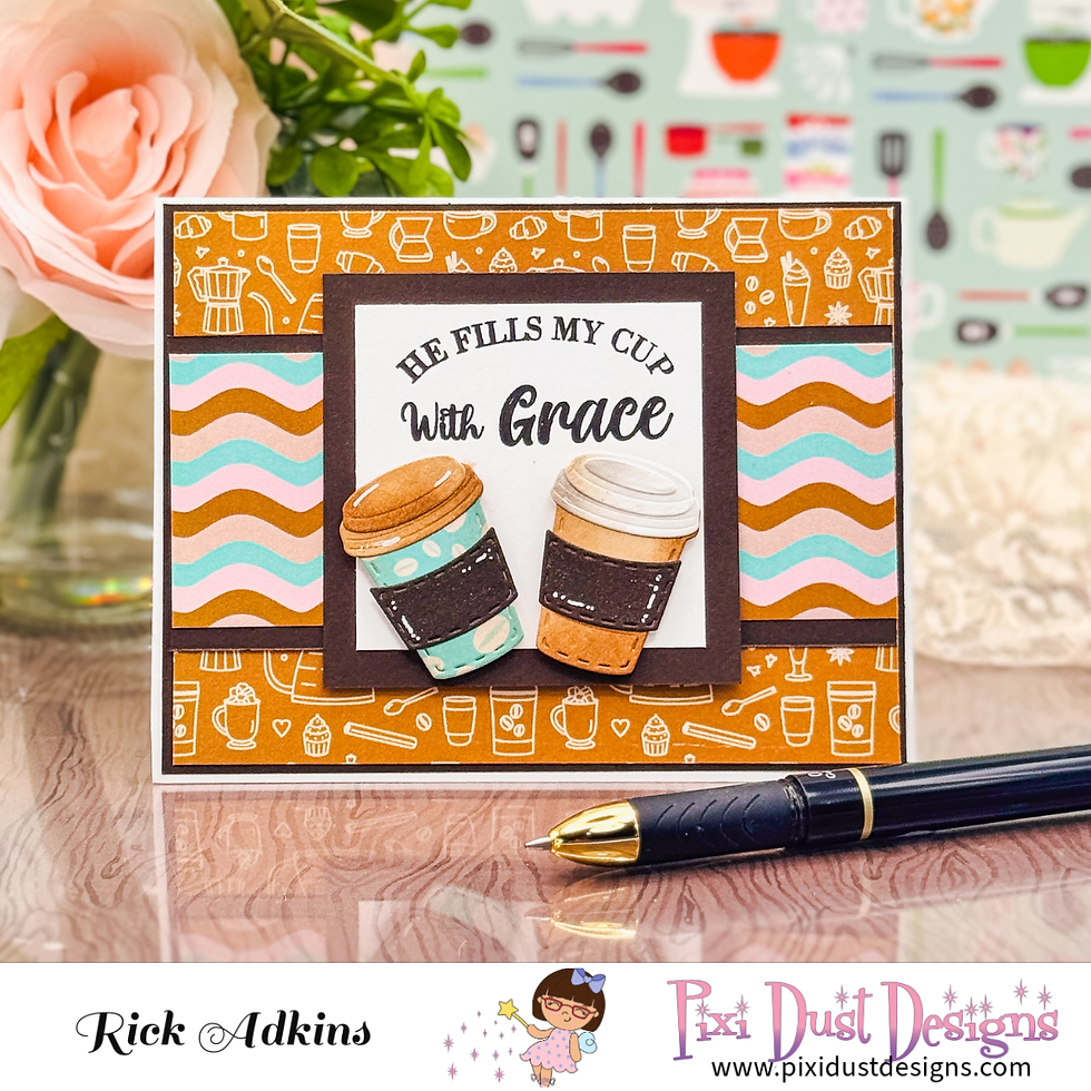 Handmade greeting card with two coffee cups and text He Fills My Cup With Grace on a desk, with a pen and floral background.
