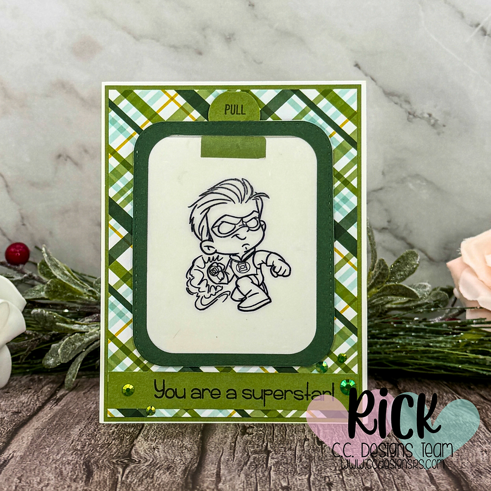 Card with a superhero drawing and "Pull" tab. Plaid green border, text reads "You are a superstar!" set against a wood surface.