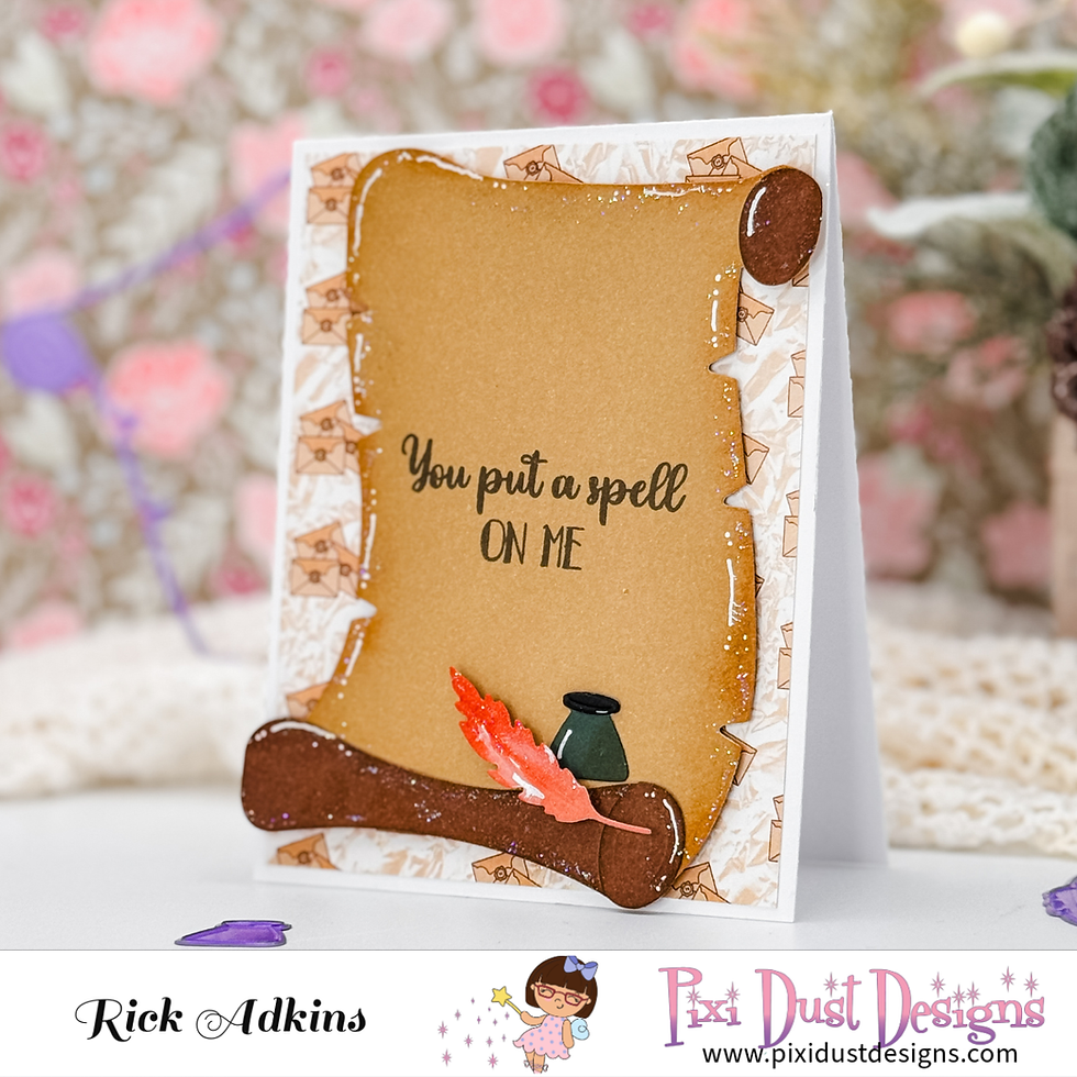 Card with vintage scroll design reads "You put a spell on me," featuring a red quill and ink pot. Background has soft floral patterns.