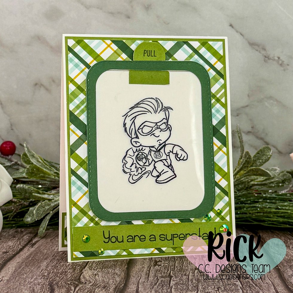Card with cartoon superhero, green plaid border, and "You are a superstar" text. Pull tab above drawing. Festive greenery in background.