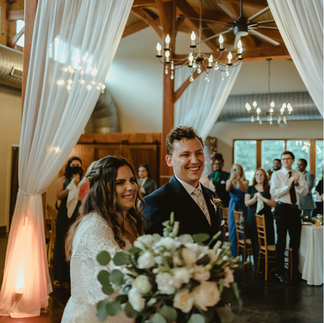 newlywed couple entering their reception inside the Barns at Ashton Creek Vineyard