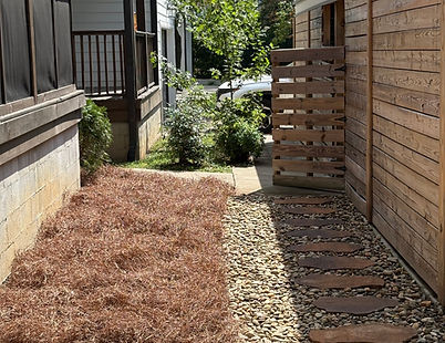 Walk path installation with Pigeon River rock and pine straw landscape accents.
