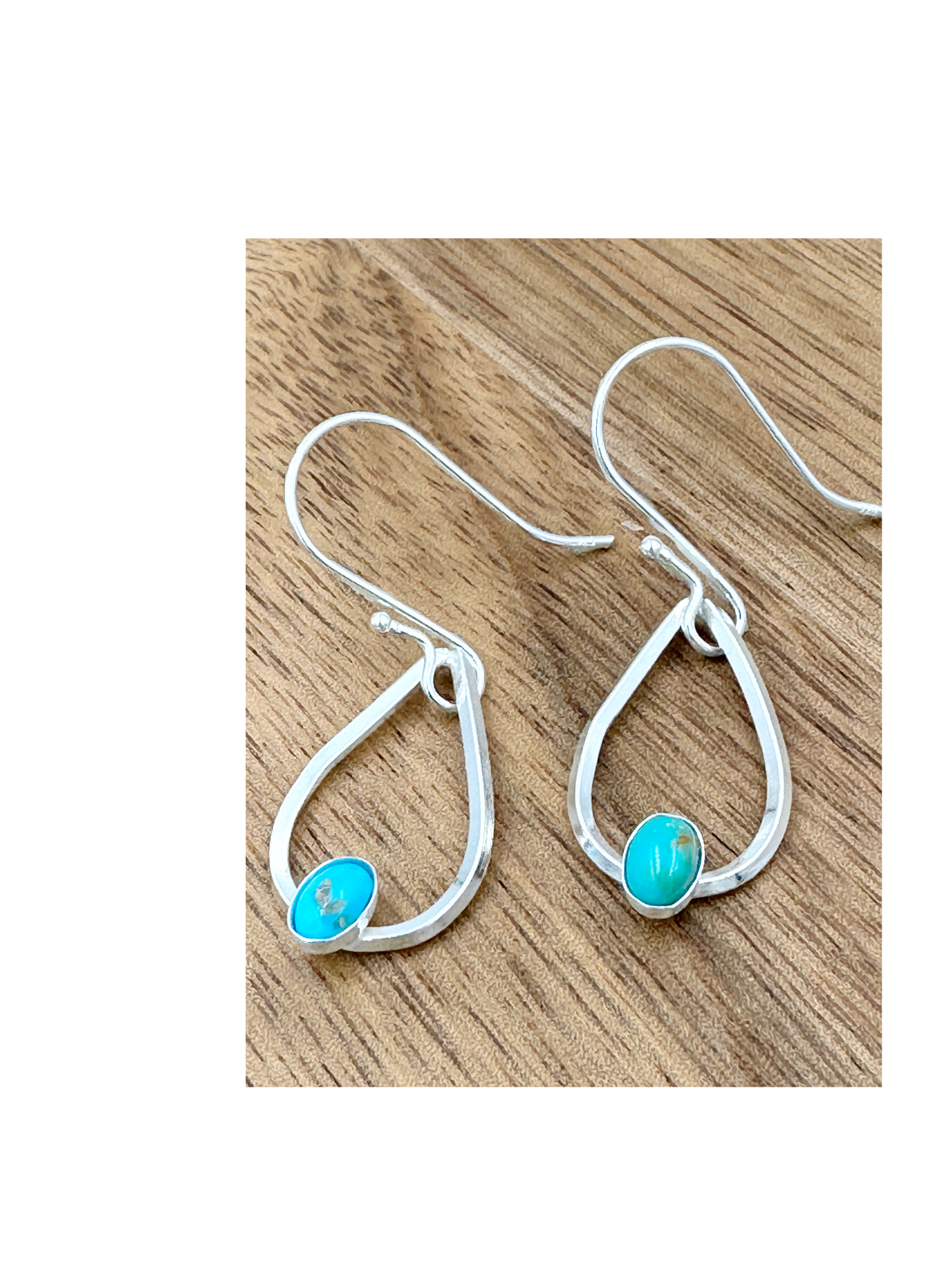 Sterling silver teardrop earrings set with turquoise cabochons