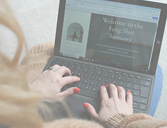 I woment with red nail working on the feng shui santuary website