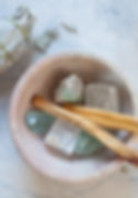 crystals and palo santo sticks in bowl