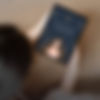 Tablet showing feminine entrepreneurship ebook cover, held by woman in soft natural light.