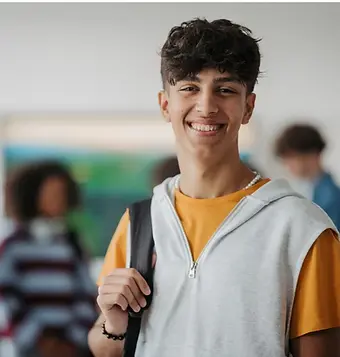 Smiling teenage boy, showcasing the empowerment of life coaching for teens.