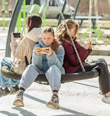picture showing teens using mobiles, depicting the internet addiction among teens.