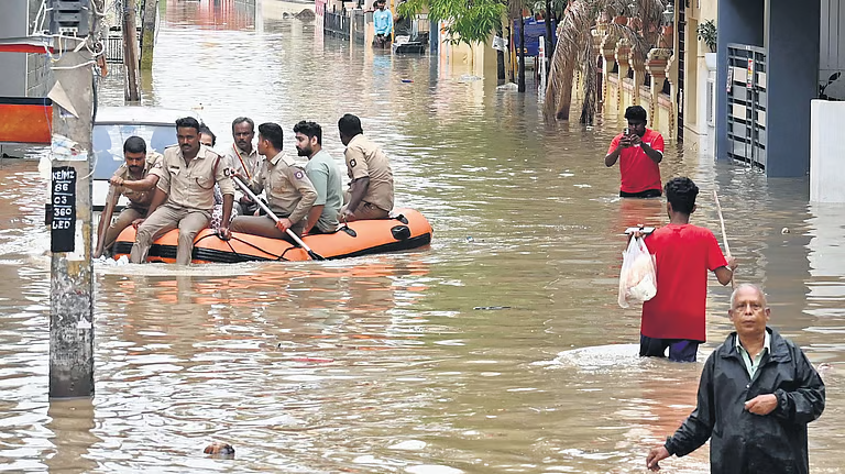 Residents of Sai Layout in Bengaluru were evacuated on a dinghy after heavy rains submerged the area on Monday.