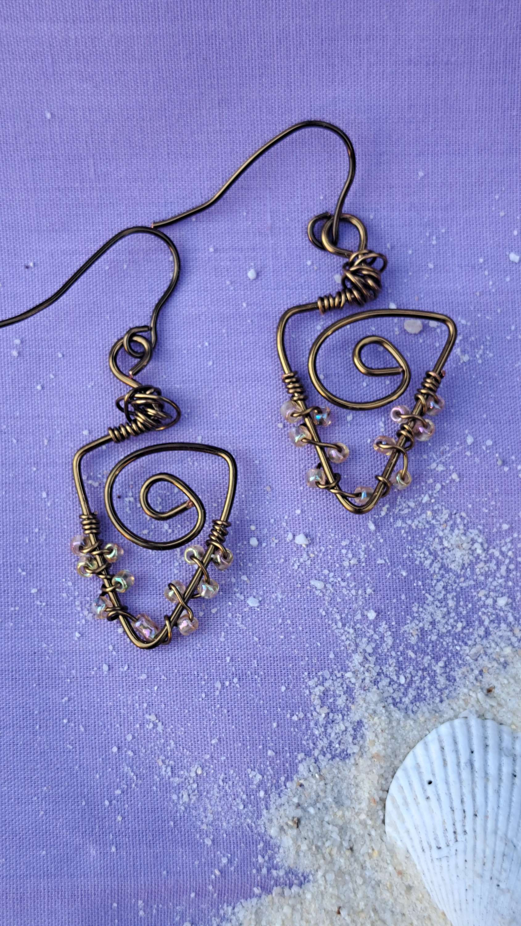 Handmade antique brass tone dangle earrings with wire wrap and beads. 