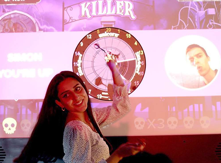 A woman playing AR Darts
