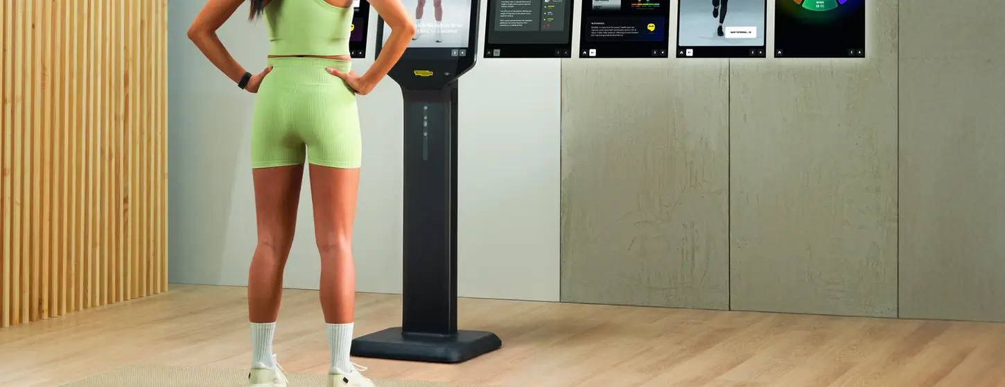 A woman using the Technogym Checkup device