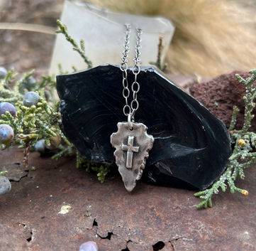 Sterling Silver Arrowhead pendant with Cross. Approximately 1” in length. Handmade to order and can be personalized on reverse. Either sterling silver oxidized rope chain or adjustable leather cording.