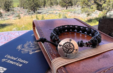 Lava bead bracelet with sterling silver button with compass image