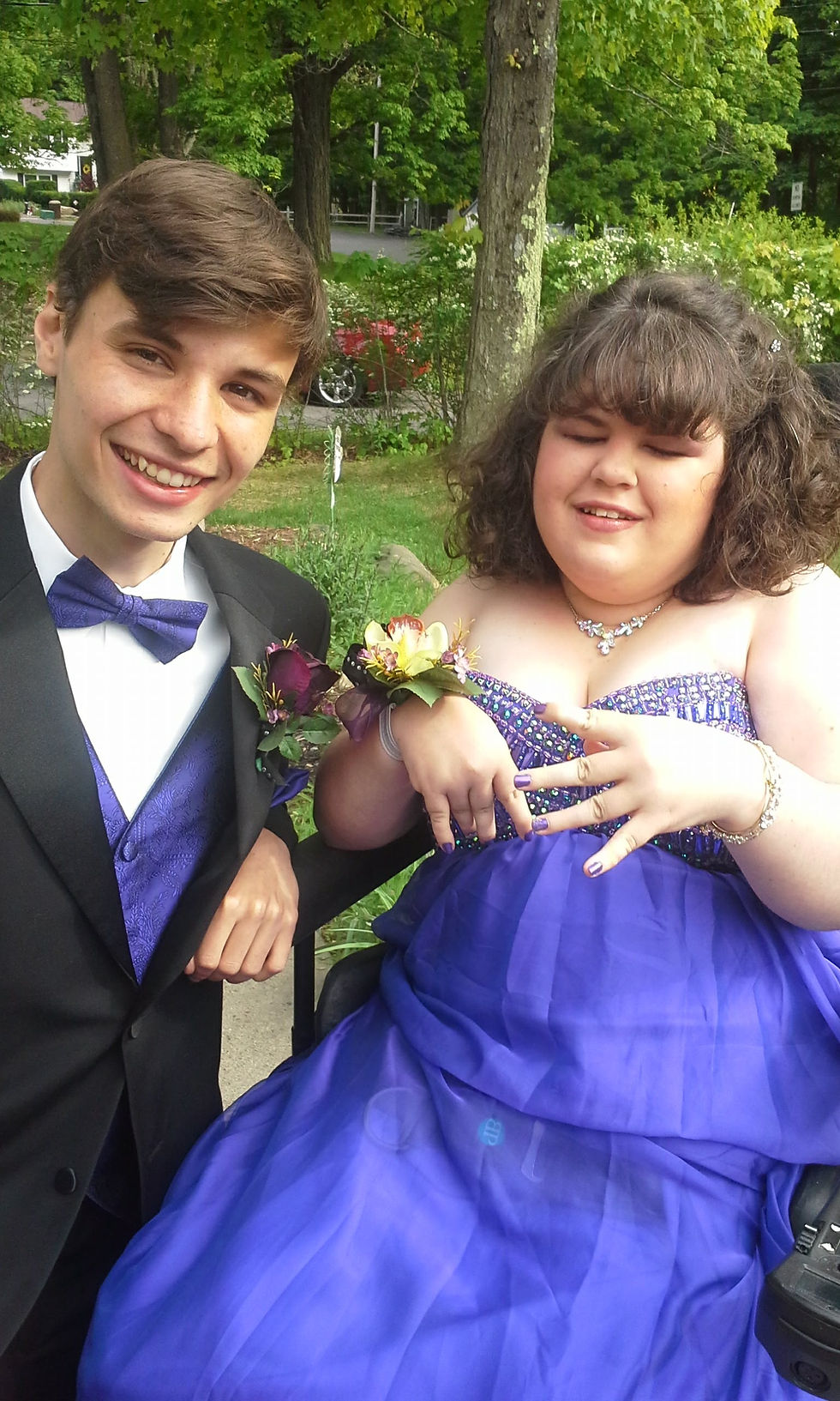 Photo: I am in a purple dress with colorful purple toned sequins on the bodice. Jake, my prom date is dressed to the nines in a black tux with purple bowtie.