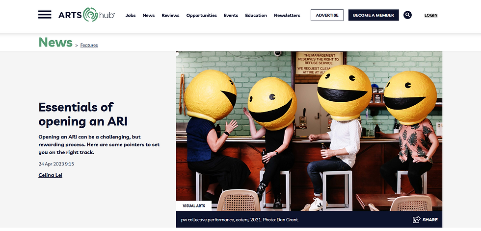Four people sitting with large yellow smiley face helmets, holding drinks in a bar with green-tiled walls.