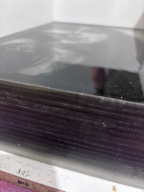 Figure 2. Studio process shot of first board coming of and revealing the layers, 2026, photograph by artist