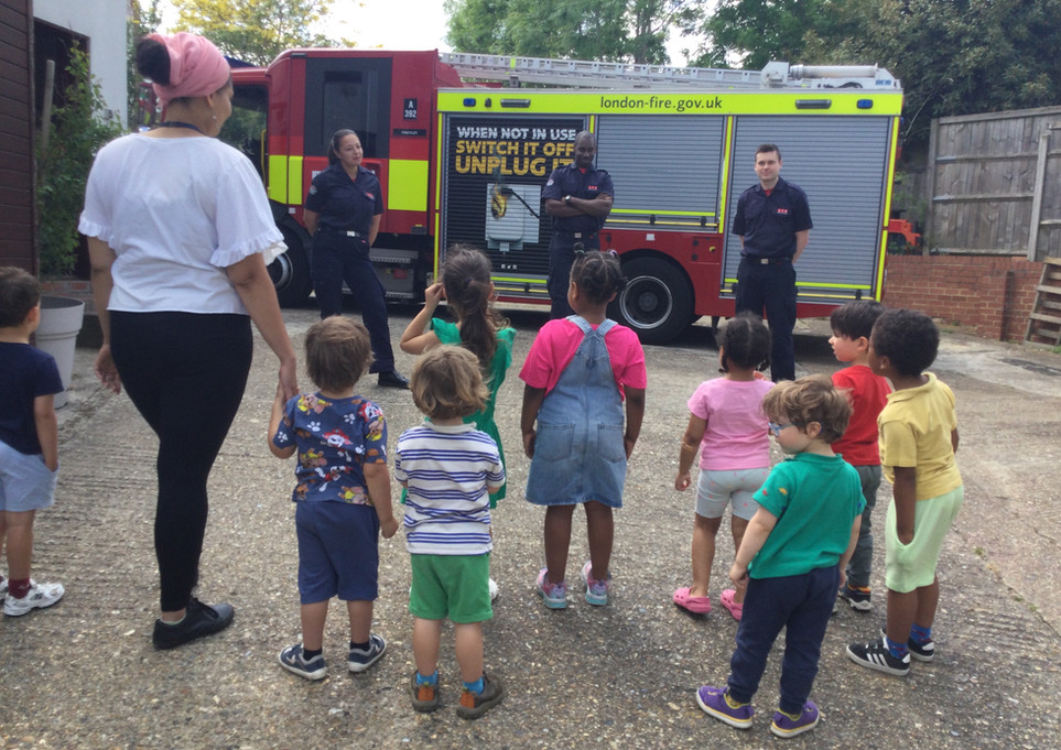 Fire engines and firemen visiting a group of children from Kidz Kabin Pembroke Studios in Muswell Hill